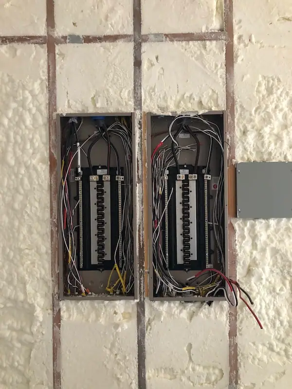 Two electrical panels wired side by side during an A to Z Electric install